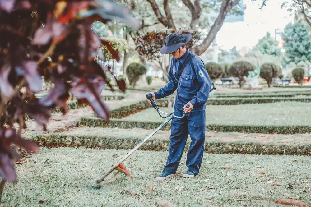 Garden care team measuring a lawn for a maintenance quote